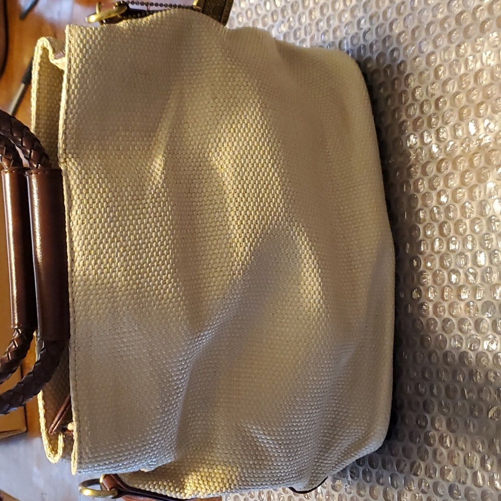 Relic woven natural raffia w/leather trim.  Cute
